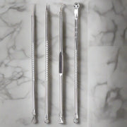 Set of four stainless steel acne removal tools, designed to safely and effectively extract blackheads and comedones from the skin.